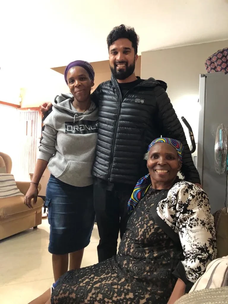 Project site — community members gathered indoors in living room