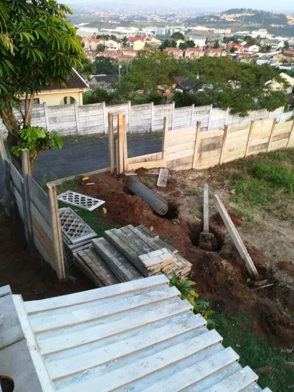 Project site — terraced steps and fencing with city view