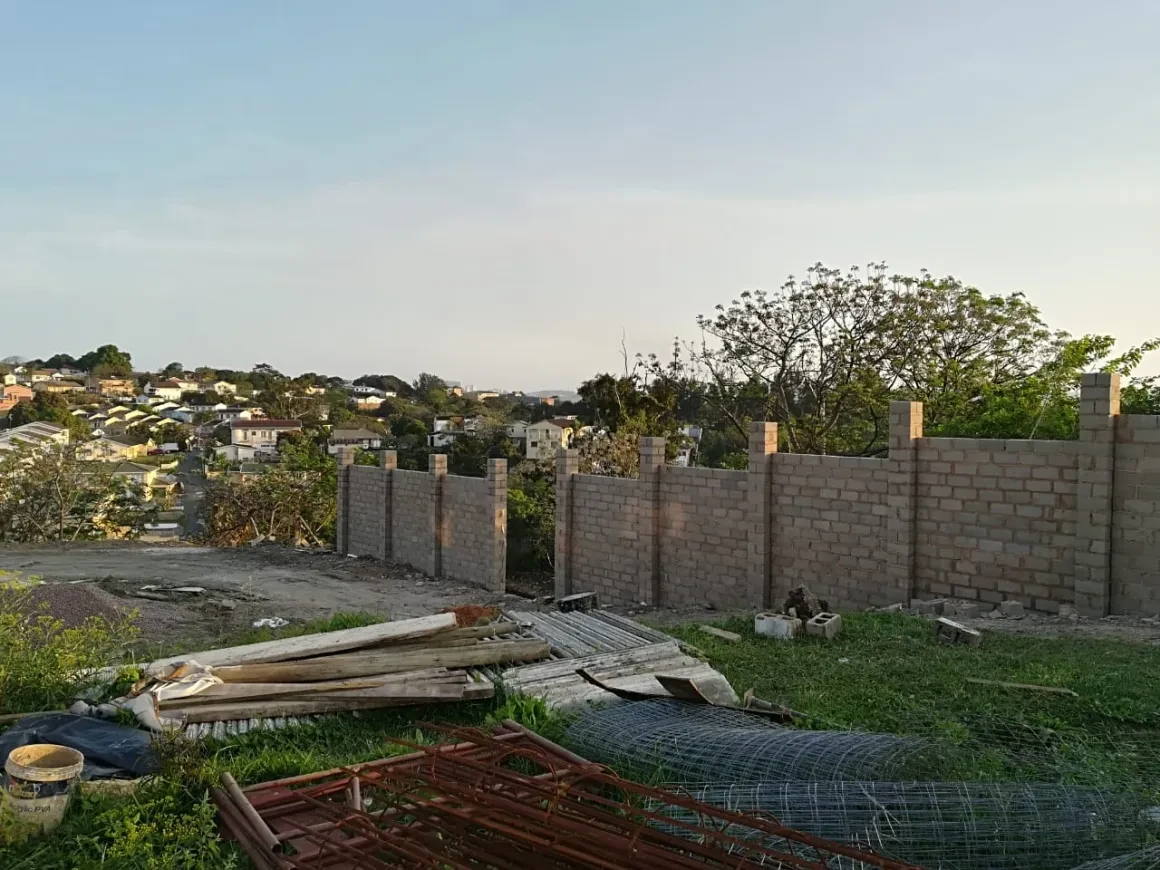 Project site — perimeter wall construction with Durban skyline