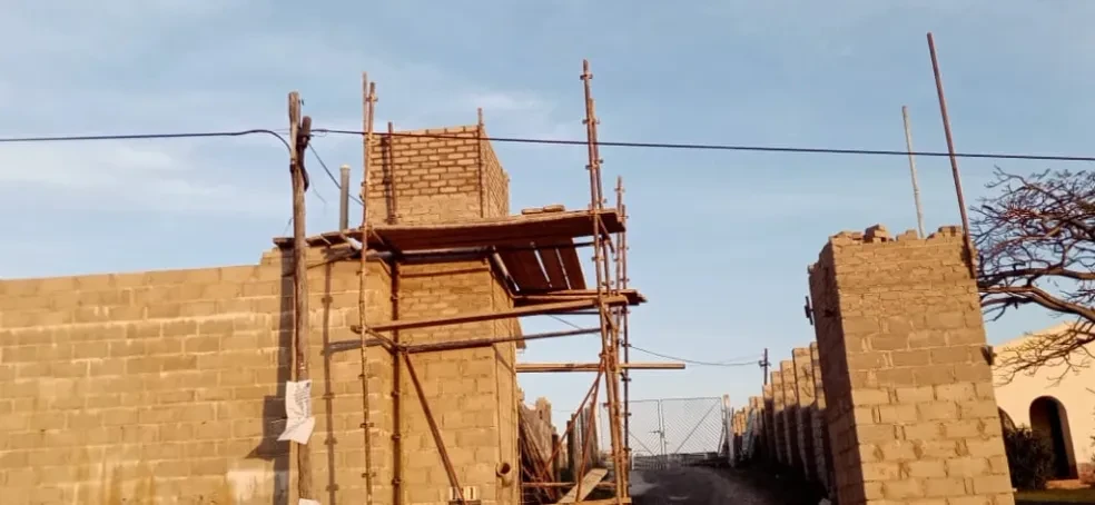 Project site — brick building under construction with scaffolding