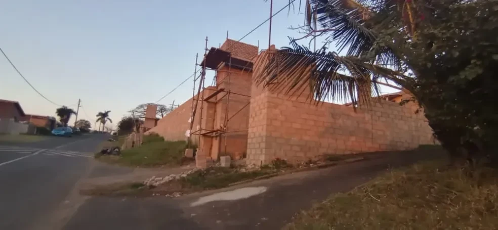 Project site — residential building under construction in tropical setting with palm trees