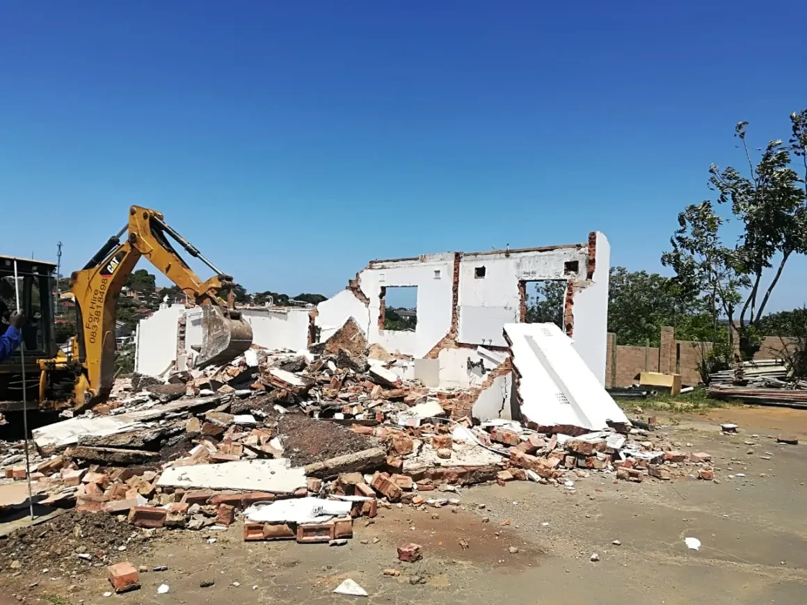 Project site — demolition site with heavy machinery and debris