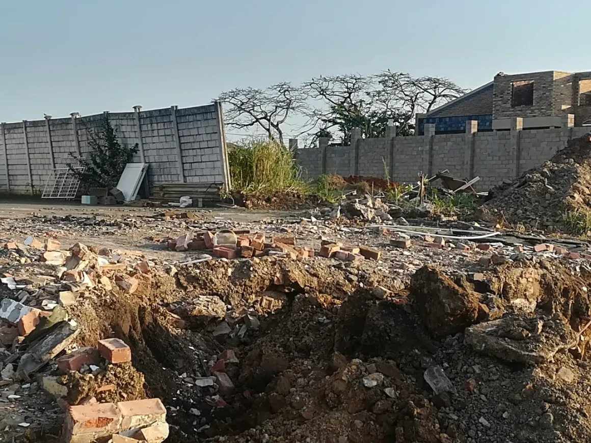 Project site — excavated earth with concrete block structures