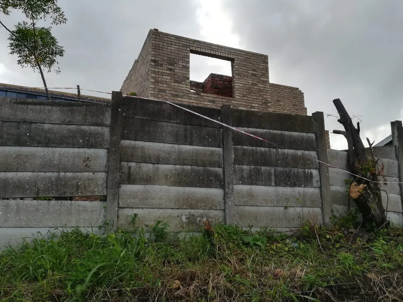Project site — dump truck loaded with soil on cleared site with concrete manhole rings in foreground