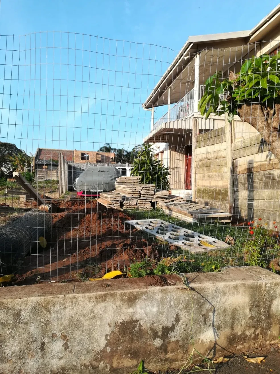 Project site — terrace area with concrete fencing and two dogs