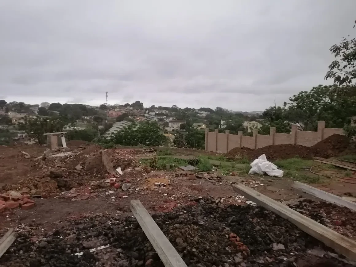 Project site — construction site with residential buildings in background