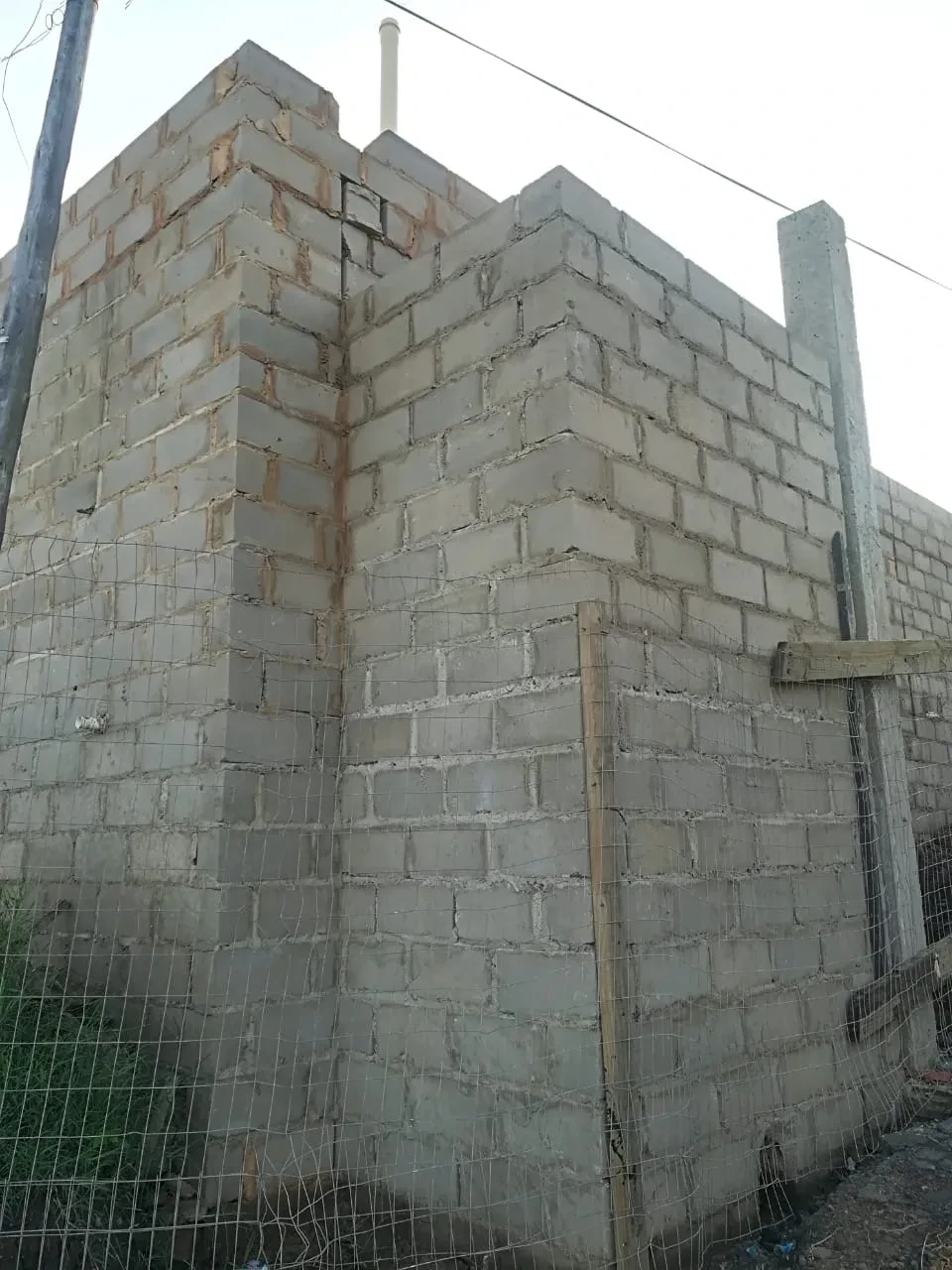 Project site — unfinished concrete building under construction
