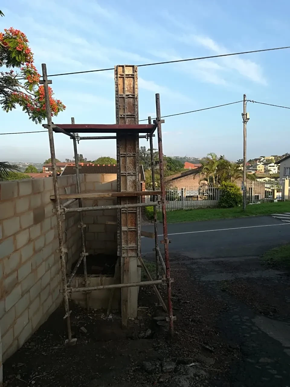 Project site — construction scaffolding and residential buildings