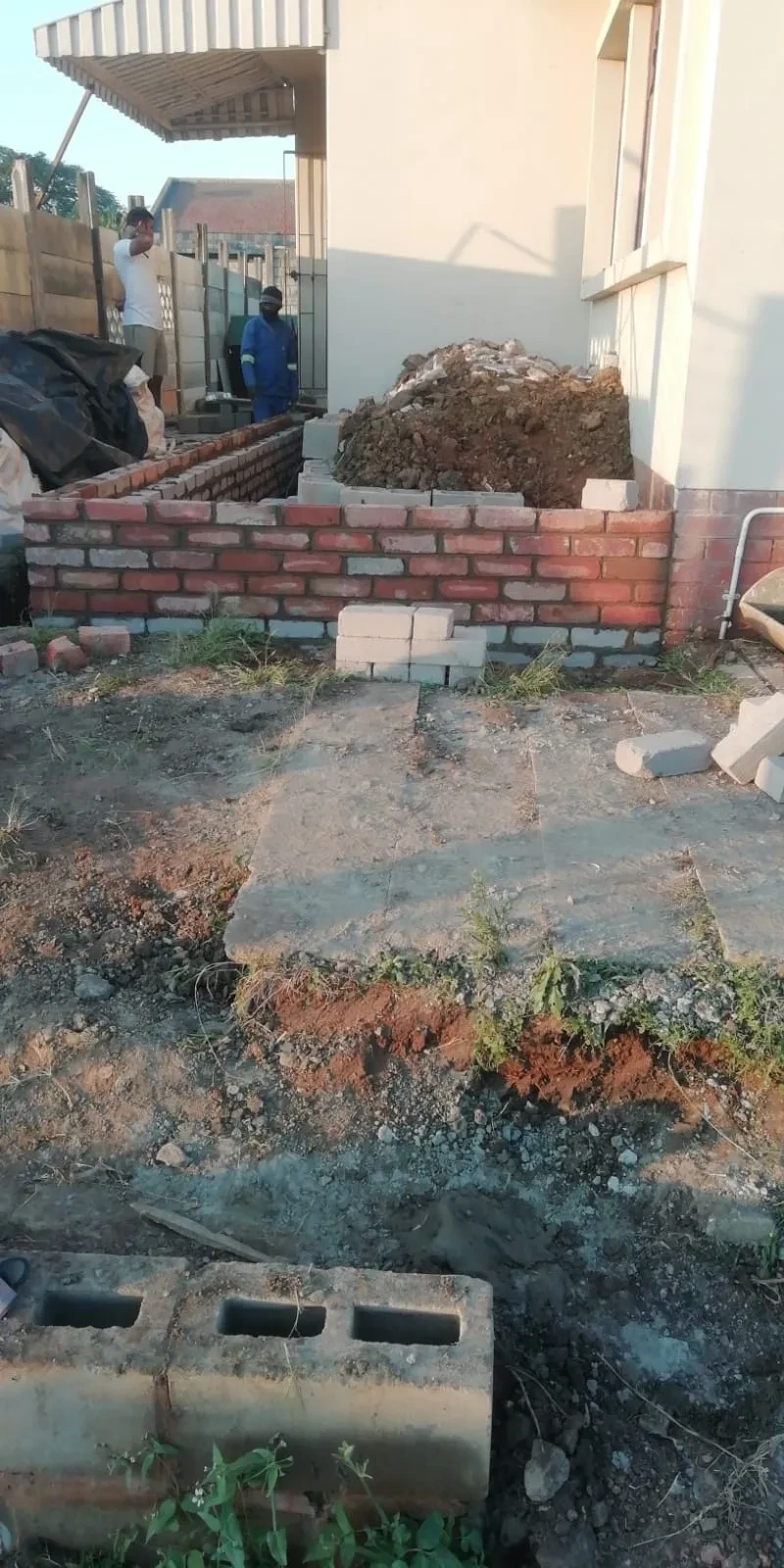 Project site — brick walls under construction with building materials