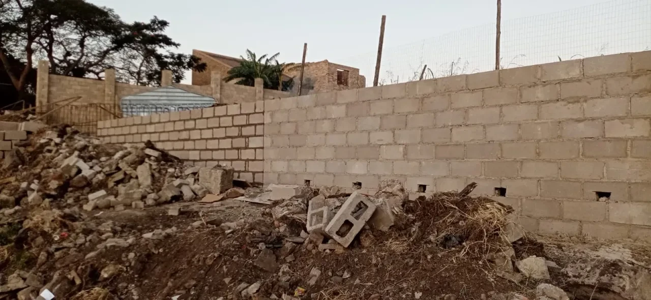 Project site — concrete block walls with debris and rubble