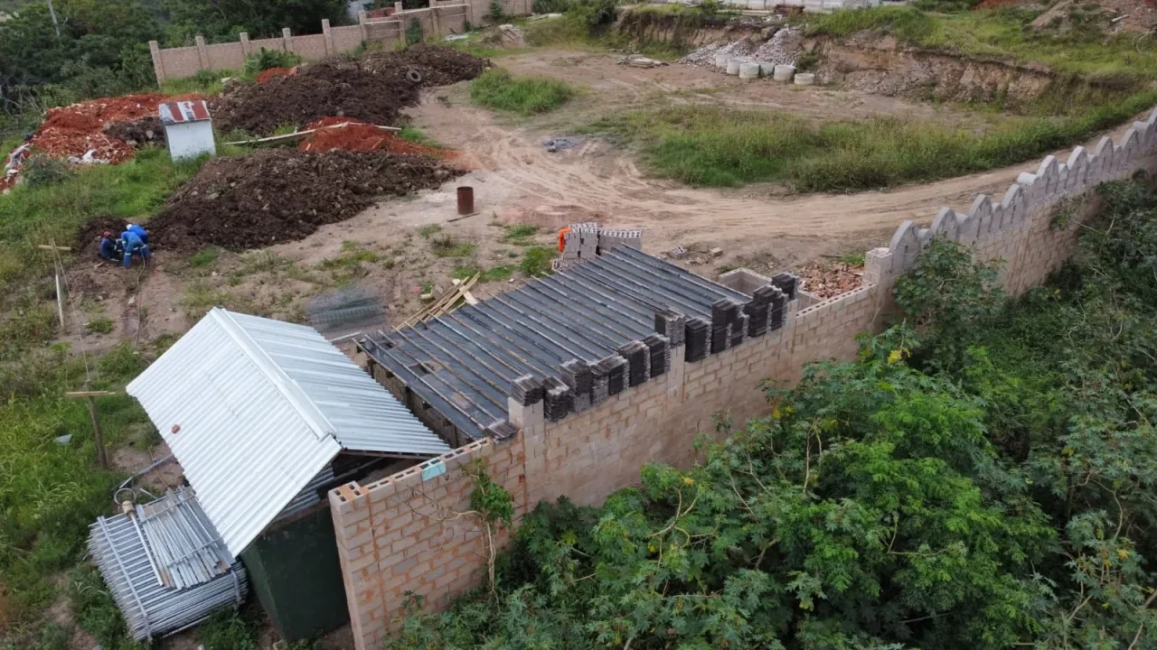 Project site — aerial view of roofing structure and crenellated perimeter wall with valley