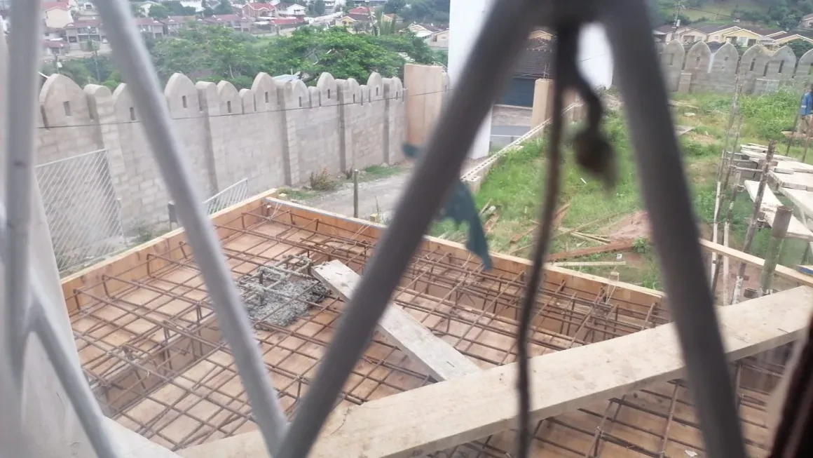 Project site — reinforced concrete slab formwork with rebar grid and crenellated wall